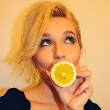 Woman Sucking on a Lemon