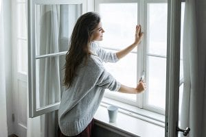 Woman Closing a Window